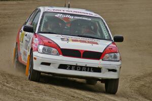 Jan Zedril / Jody Zedril on the high bank of SS1 in their Mitsubishi Lancer ES.