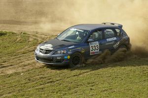 The Wyatt Knox / Martin Headland Mazda Speed 3 throws gravel on the infield section of SS1.