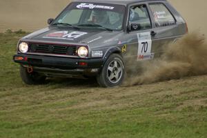Chris Duplessis / Catherine Woods kick up dirt on SS1 in their VW GTI.
