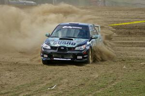 Mark Fox / Jake Blattner spray gravel in the infield of SS1 in their Subaru WRX STi.