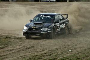 Pat Moro / Jeremy Wimpey drive though the dust their own Subaru WRX STi created on SS1.