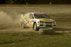 Andi Mancin / Maciej Wislawski drifts his Mitsubishi Lancer Evo 9 sideways on a corner on SS1.