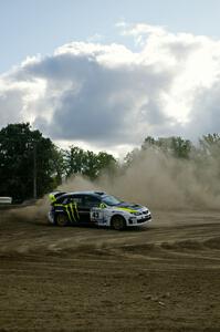 Ken Block / Alex Gelsomino drift through a hard left hander in their Subaru Impreza WRX STi on SS1.