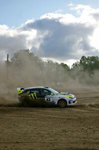 Ken Block / Alex Gelsomino power out of a hard left hander in their Subaru Impreza WRX STi on SS1.