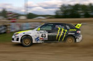 Ken Block / Alex Gelsomino drift through a left hander in their Subaru Impreza WRX STi on SS1.(3)