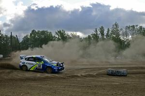 Dust trailing the car mimics the cloud above the Travis Pastrana / Christian Edstrom Subaru WRX STi on SS1.