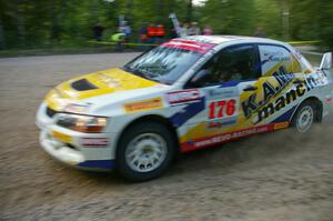 The Andi Mancin / Maciej Wislawski Mitsubishi Lancer Evo 9 at sped on a left-hander on SS2.