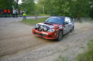 The Piotr Wiktorczyk / Grzegorz Dorman Subaru WRX STi rockets through a sweeper on SS2.