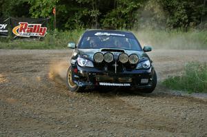 Mark Fox / Jake Blattner accelerate out of the uphill hairpin on SS4 in their Subaru WRX STi.