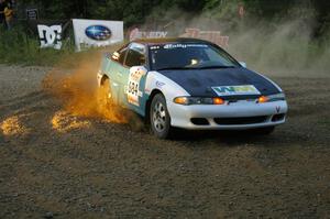 Adam Markut / Chris Gordon drift their Eagle Talon through the spectator-filled uphill hairpin on SS4.