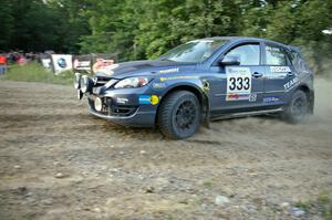 Wyatt Knox / Martin Headland prepare for a hard left-hand hairpin on SS4 in their Mazda Speed 3.