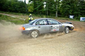 Dan Adamson / Jeremiah Schubitzke take to uphill hairpin on SS4 in their Saturn SL2.