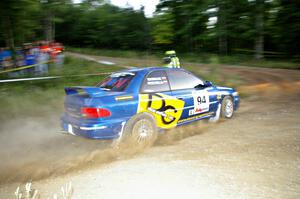 Piotr Fetela / Mariusz Malik fling their Subaru Impreza toward the uphill hairpin on SS4.