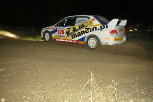 Andi Mancin / Maciej Wislawski in their Mitsubishi Lancer Evo 9 through the downhill hairpin on SS7.