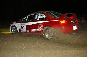 Lauchlin O'Sullivan / Karen Wagner drift their Dodge SRT-4 at the downhill hairpin on SS7.