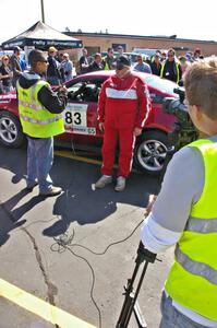 Mark Utecht is interviewed in front of his Ford Mustang that he shared with Rob Bohn.