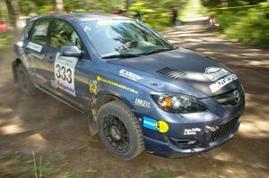 Wyatt Knox / Martin Headland drift through a 90-right on SS8 in their Mazda Speed 3.