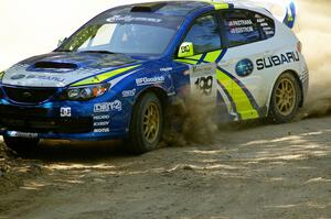 Travis Pastrana / Christian Edstrom in their Subaru WRX STi at speed through an uphill right on SS11.