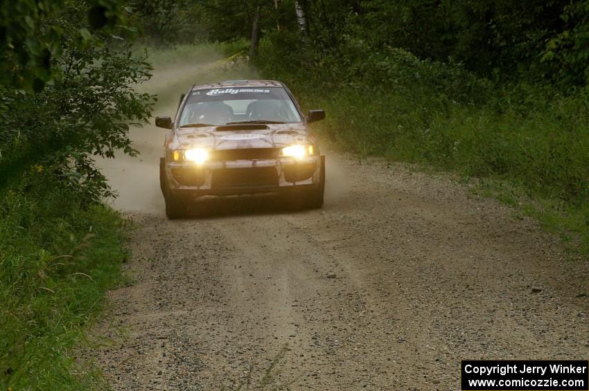 Bob Olson / Conrad Ketelsen in their Subaru Impreza drive up a gradual incline on the practice stage.