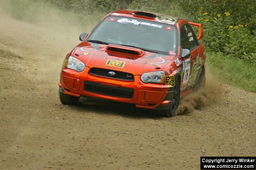 The Nate Conley / Adam Kneipp Subaru WRX STi at speed on the practice stage.