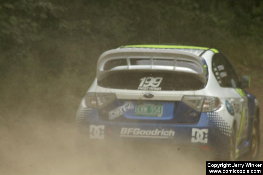 Travis Pastrana / Christian Edstrom power away out of a corner in their Subaru WRX STi on the practice stage.