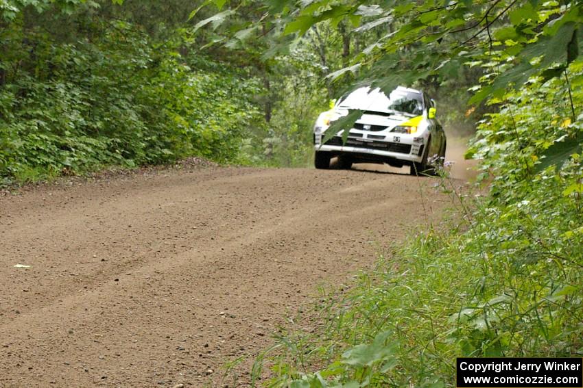 Ken Block / Alex Gelsomino come up over a rise in their Subaru Impreza WRX STi on the practice stage.