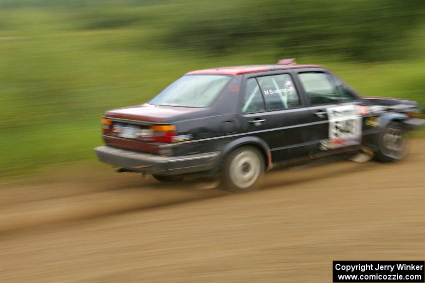 Matt Bushore / Kim DeMotte drift their VW Jetta out of a fast left hander on the practice stage.