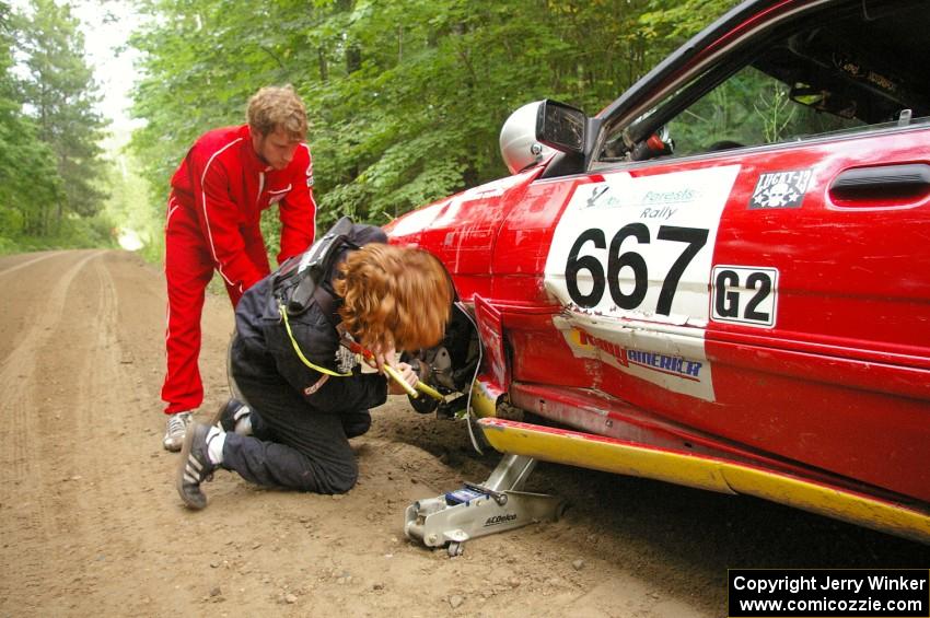 The Paul Donlin / Elliot Sherwood Ford Escort slid into a boulder on the outside of an uphill right hander during practice.