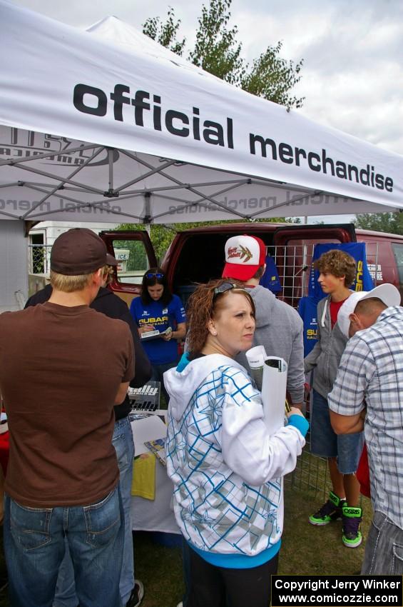 Emily Burton-Weinman takes care of the crowd of customers at the Rally-America Store tent.