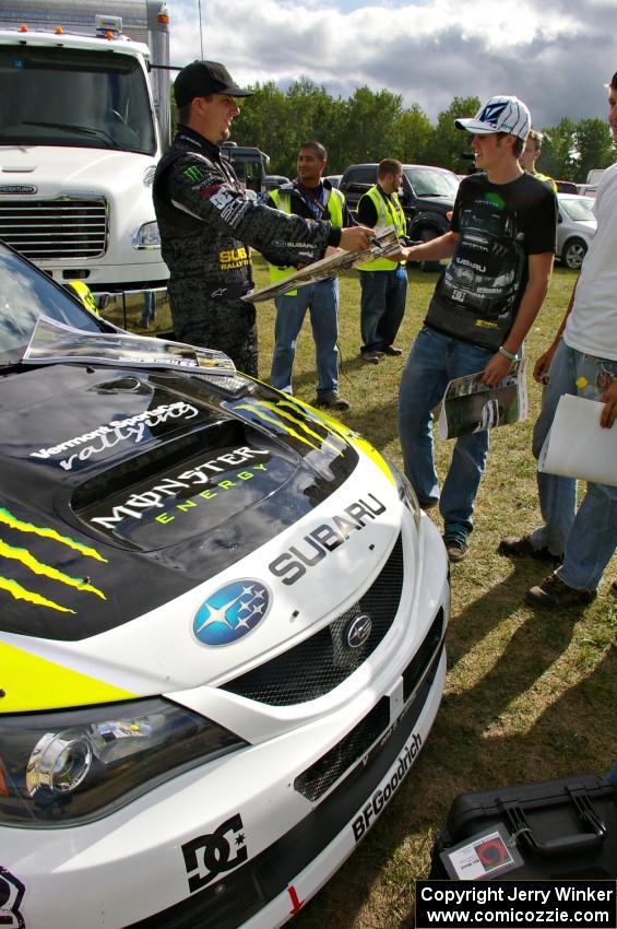 Ken Block signs autographs for fans in front of the Subaru WRX STi that he and navigator Alex Gelsomino shared.