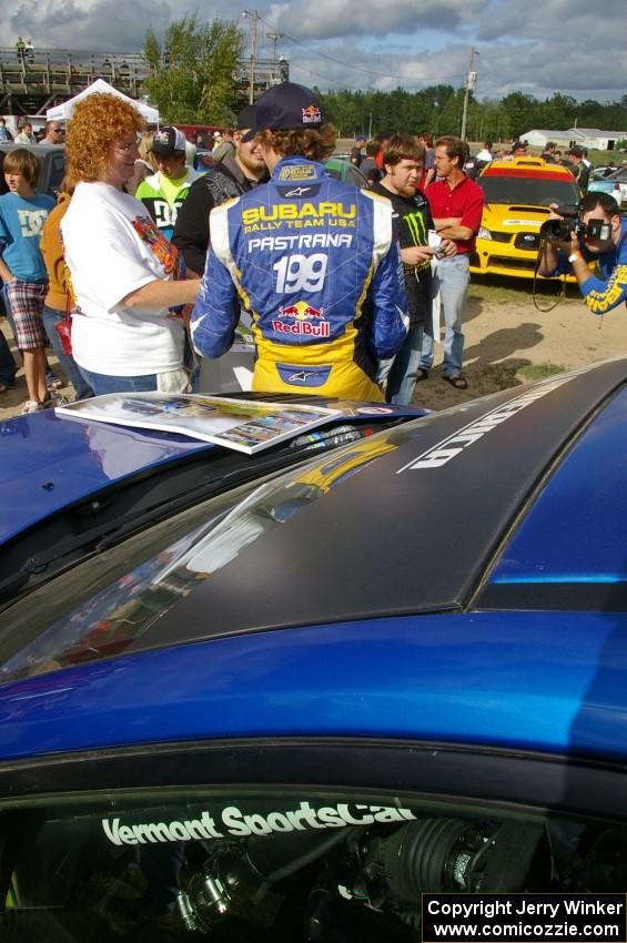 Travis Pastrana signs autographs for fans in front of the Subaru WRX STi that he and navigator Christian Edstrom shared.