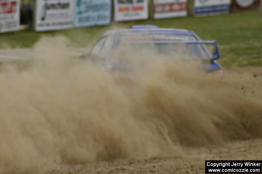Janusz Topor / Michal Kaminski blast gravel coming off the high bank on SS1 in their Subaru WRX STi.