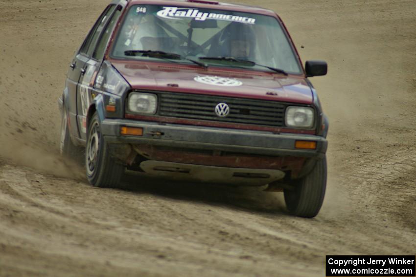 Matt Bushore / Kim DeMotte drift their VW Jetta on the high bank on SS1.