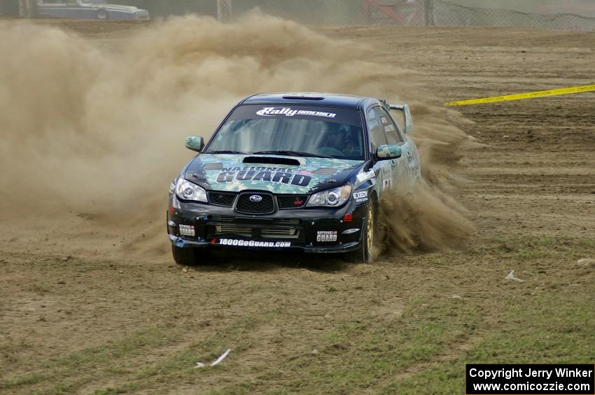 Mark Fox / Jake Blattner spray gravel in the infield of SS1 in their Subaru WRX STi.