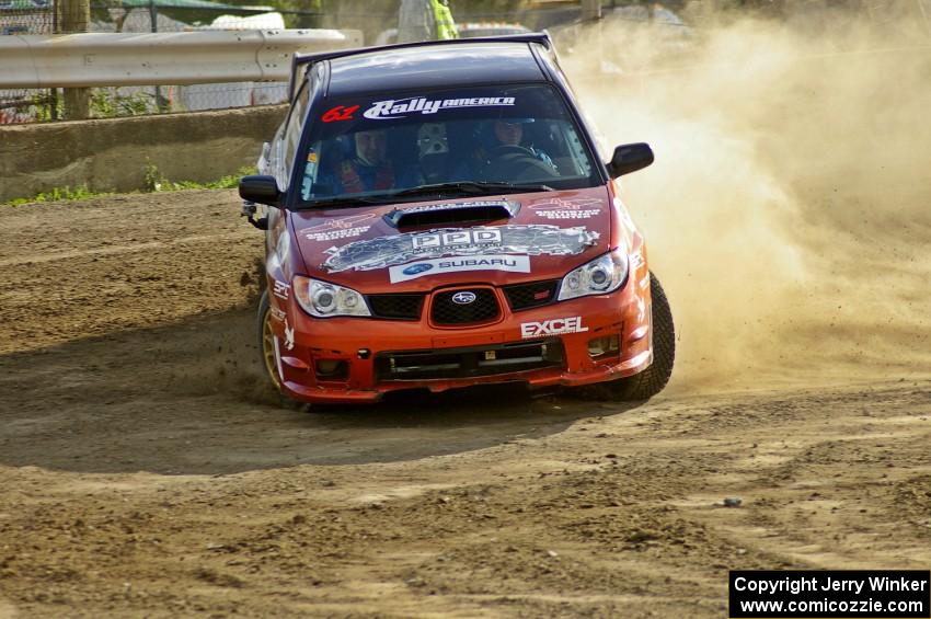 The Piotr Wiktorczyk / Grzegorz Dorman Subaru WRX STi drifts hard through a hairpin on SS1.