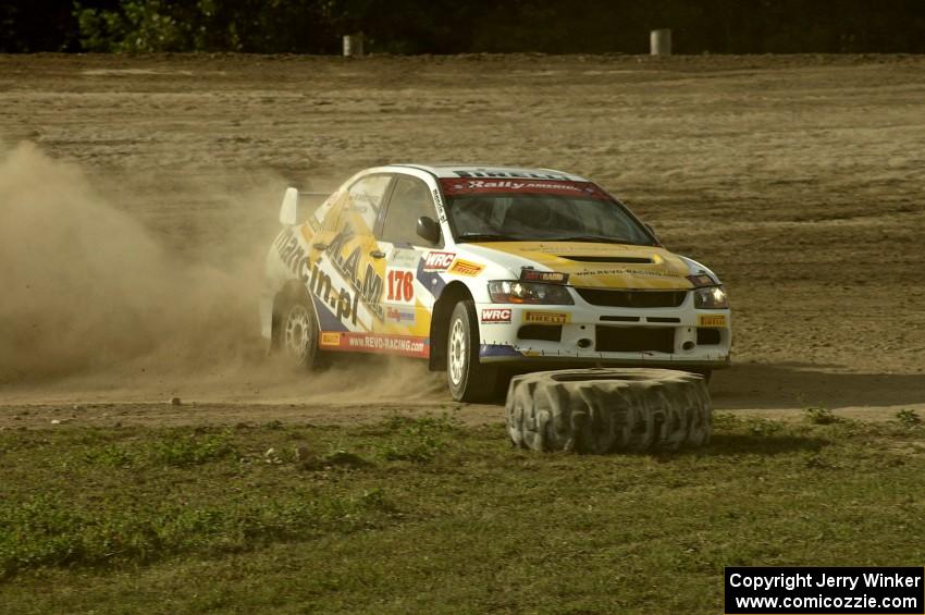 Andi Mancin / Maciej Wislawski drifts his Mitsubishi Lancer Evo 9 sideways on a corner on SS1.