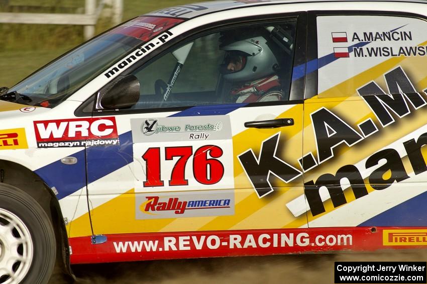 Andi Mancin / Maciej Wislawski speed down a straight in their Mitsubishi Lancer Evo 9 on SS1.