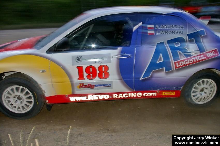 Arkadiusz Gruszka / Lukasz Wronski drift their Mitsubishi Lancer Evo 9 through a fast left-hander on SS2.