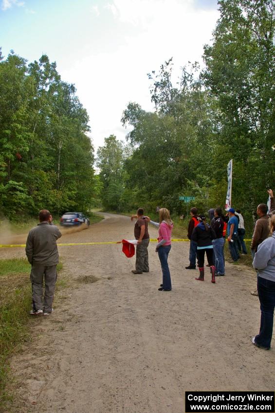 Marshalls and spectators on SS3 as the Paul Koll / Heath Nummemacher VW Golf passes by.