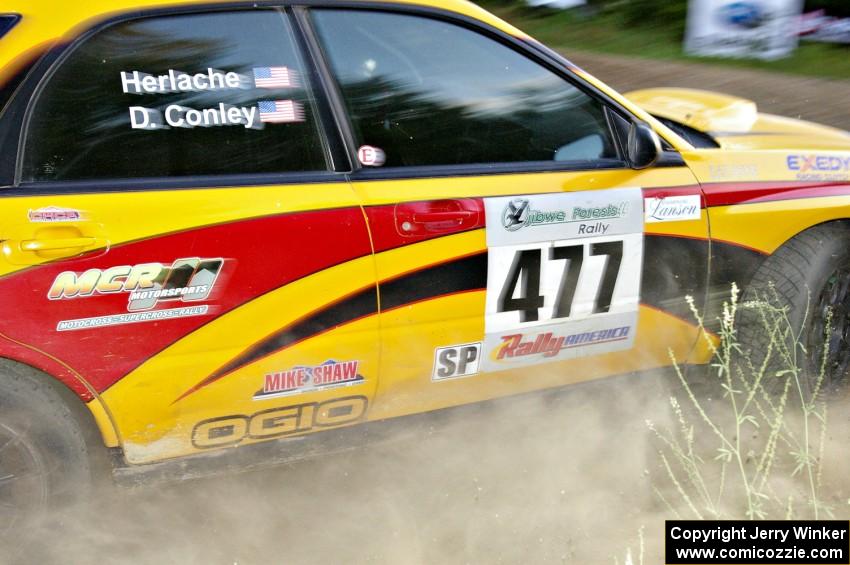Don Conley / Chris Herlache go wide in preparation for the uphill specator hairpin on SS4 in their Subaru WRX Wagon.