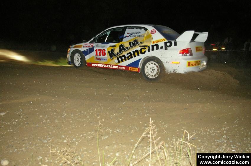 Andi Mancin / Maciej Wislawski in their Mitsubishi Lancer Evo 9 through the downhill hairpin on SS7.