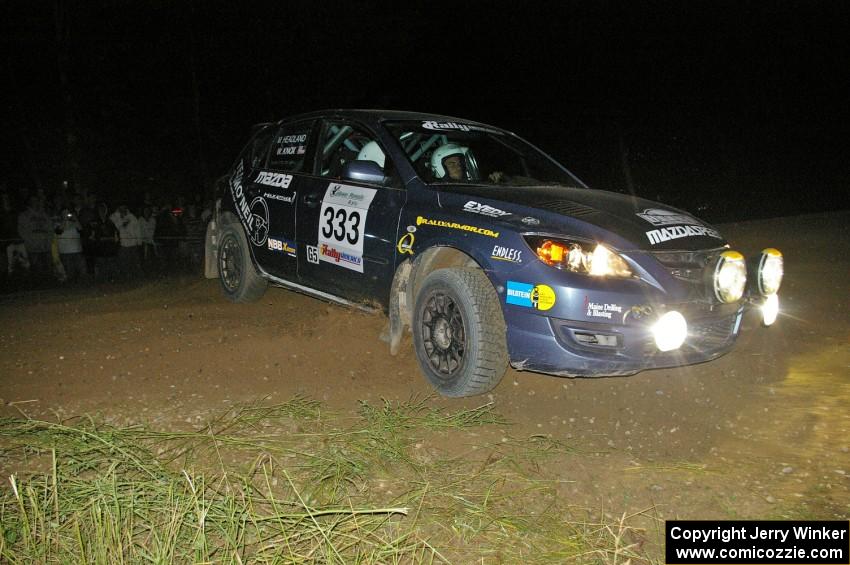 Wyatt Knox / Martin Headland apex the downhill hairpin on SS7 in their Mazda Speed 3.