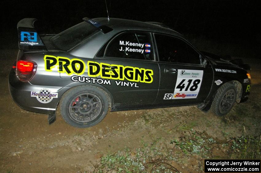 Jimmy Keeney / Missy Keeney power out of a downhill hairpin on SS7 in their Subaru WRX STi.