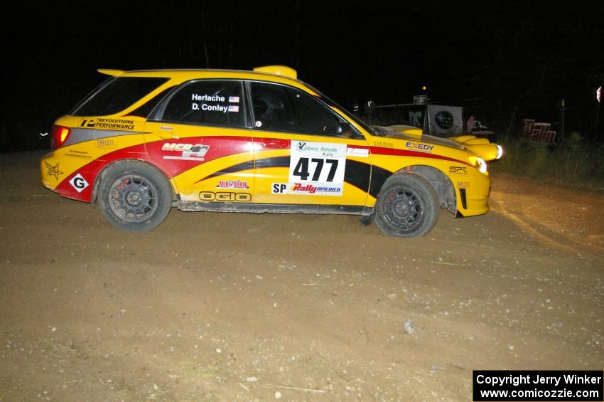 Don Conley / Chris Herlache fight heavy understeer on the downhill hairpin on SS7 in their Subaru WRX Wagon.