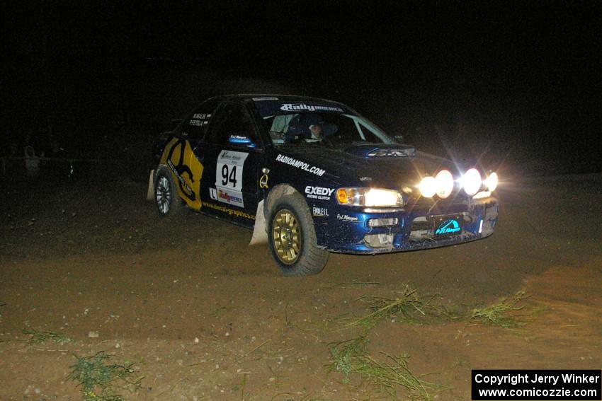 Piotr Fetela / Mariusz Malik slide wide at the downhil hairpin on SS7 in their Subaru Impreza.