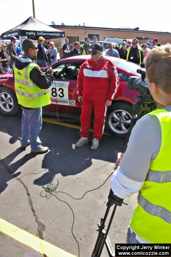 Mark Utecht is interviewed in front of his Ford Mustang that he shared with Rob Bohn.