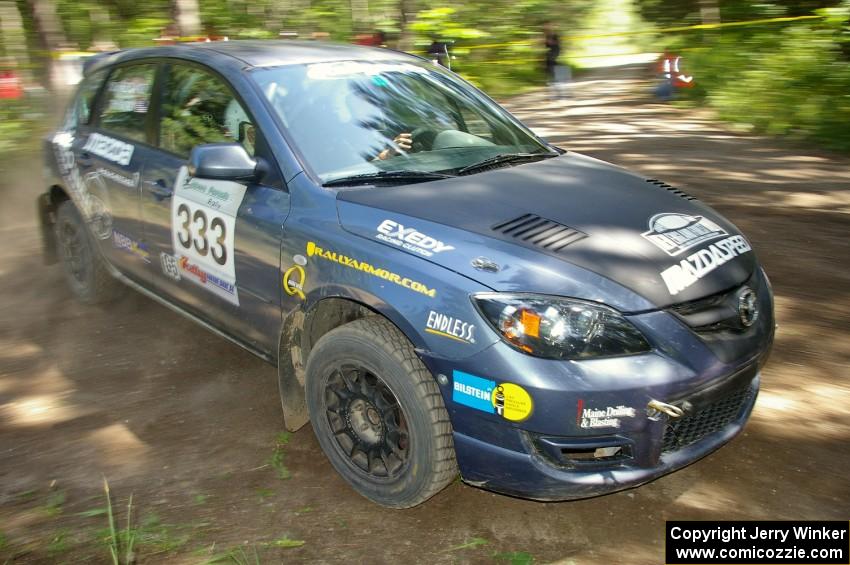 Wyatt Knox / Martin Headland drift through a 90-right on SS8 in their Mazda Speed 3.