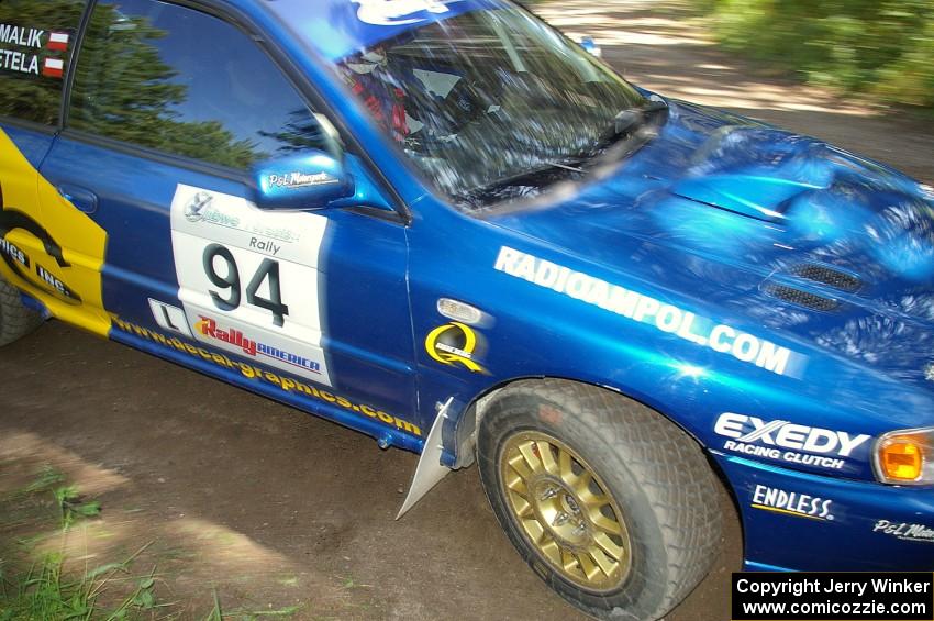 Piotr Fetela / Mariusz Malik take a close apex on SS8 in their Subaru Impreza.