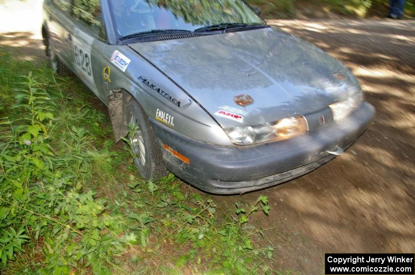 Dan Adamson / Matt Nichols apex a corner on SS8 a little more than the average car in their Saturn SL2.