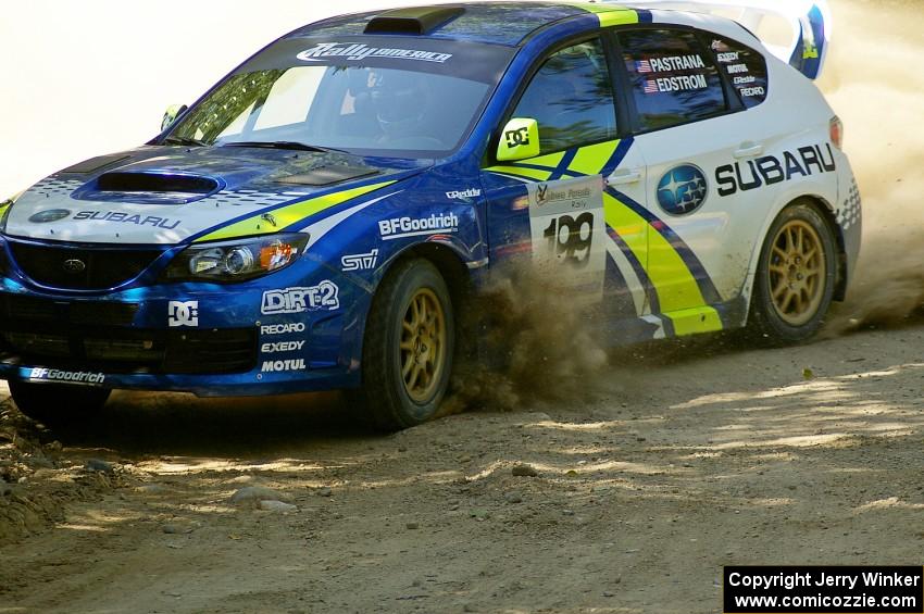 Travis Pastrana / Christian Edstrom in their Subaru WRX STi at speed through an uphill right on SS11.